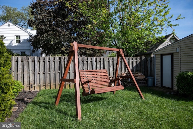 view of play area with a lawn and a fenced backyard
