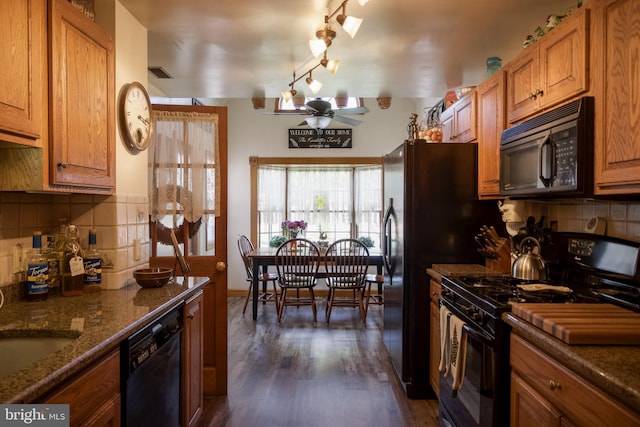 kitchen featuring brown cabinets, dark wood-style flooring, a ceiling fan, and black appliances