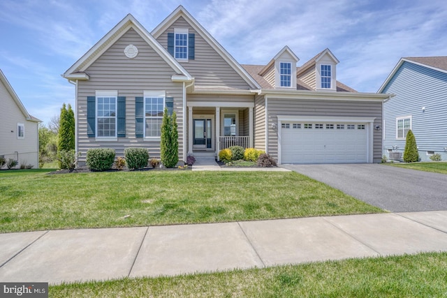 craftsman inspired home with a garage, a porch, driveway, and a front yard