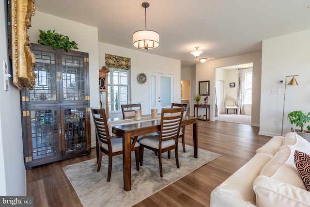 dining space with wood finished floors