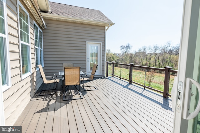 wooden deck featuring outdoor dining area