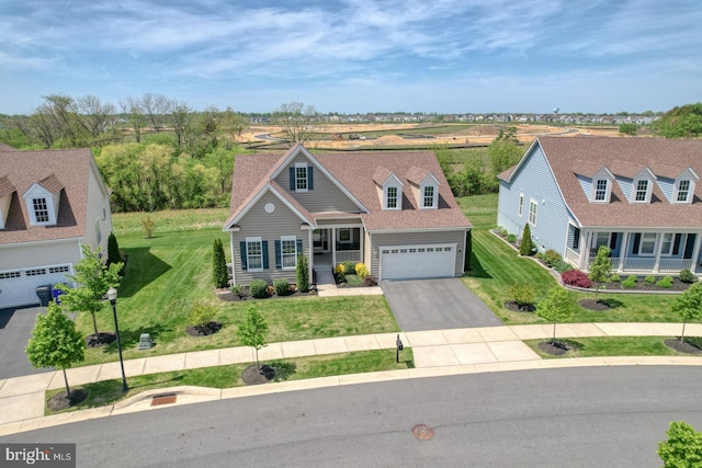 traditional home with an attached garage, a front lawn, and aphalt driveway