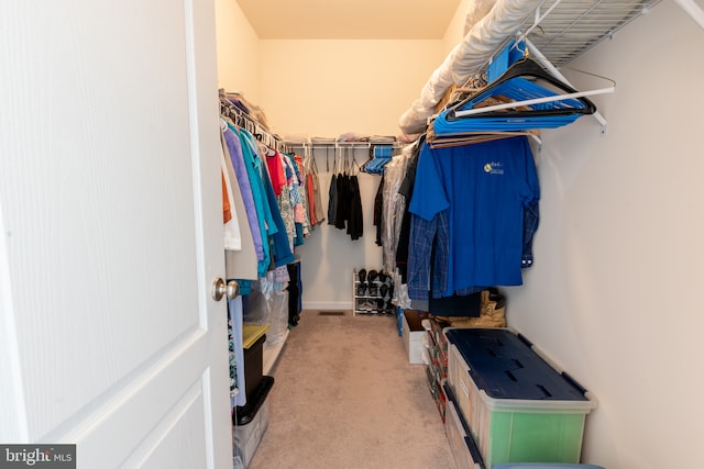 walk in closet with carpet