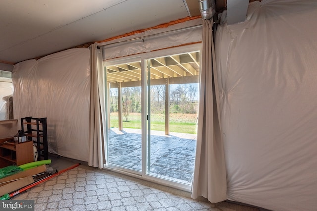 doorway to outside featuring carpet flooring