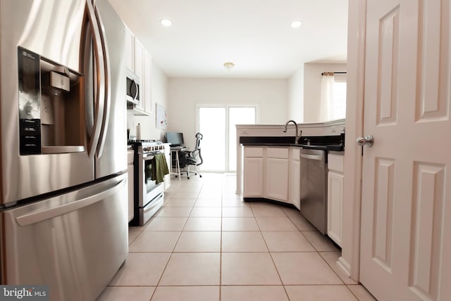 14 Wyndham Ct, Bordentown, NJ 08505 - kitchen with appliances with stainless steel finishes, dark countertops, a peninsula, white cabinets, and light tile patterned floors