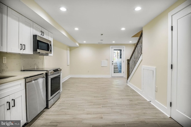 5308 5th NW, Washington, DC 20011 - kitchen with stainless steel appliances, recessed lighting, white cabinetry, light wood-type flooring, and decorative backsplash