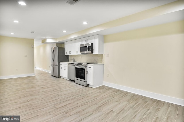 5308 5th NW, Washington, DC 20011 - kitchen featuring stainless steel appliances, light wood-style flooring, white cabinets, recessed lighting, and tasteful backsplash
