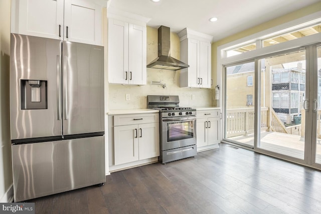 5308 5th NW, Washington, DC 20011 - kitchen featuring appliances with stainless steel finishes, wall chimney exhaust hood, light countertops, white cabinets, and dark wood-style flooring