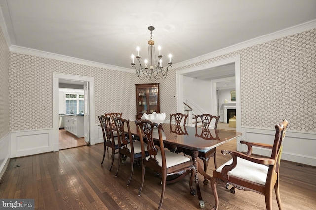 2720 35th Pl NW, Washington, DC 20007 - dining room with wallpapered walls, ornamental molding, a chandelier, dark wood-style flooring, and wainscoting
