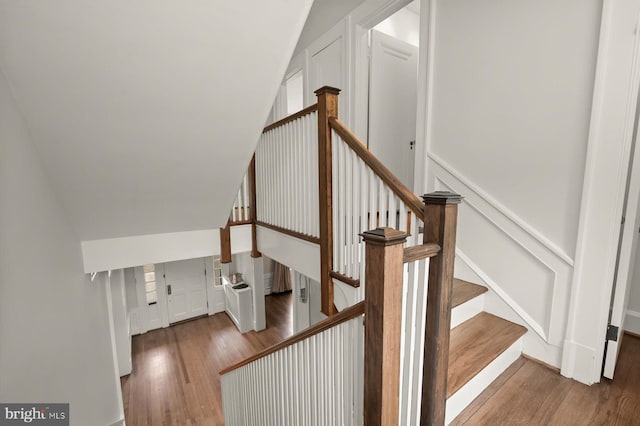 2720 35th Pl NW, Washington, DC 20007 - staircase featuring wood finished floors, a decorative wall, and wainscoting