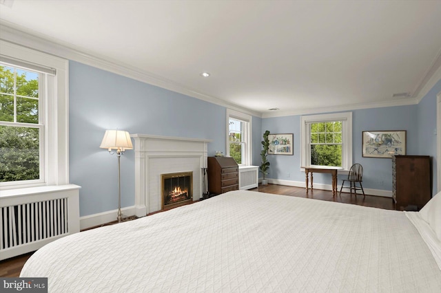 2720 35th Pl NW, Washington, DC 20007 - bedroom featuring radiator, crown molding, dark wood-style floors, a brick fireplace, and baseboards