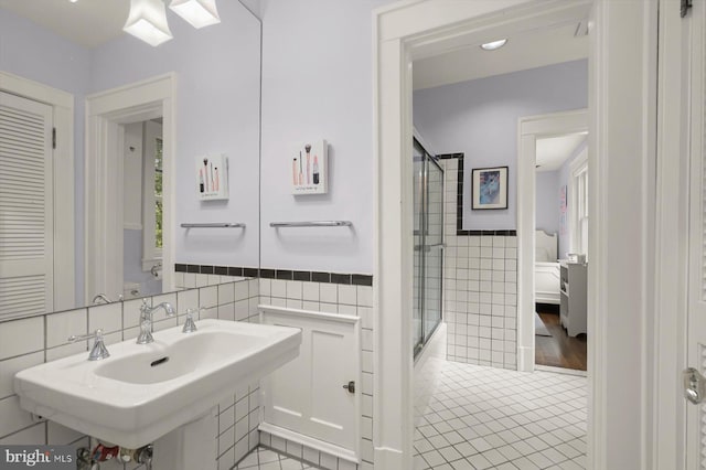 2720 35th Pl NW, Washington, DC 20007 - ensuite bathroom with tile walls, tile patterned floors, a sink, enclosed tub / shower combo, and a wainscoted wall
