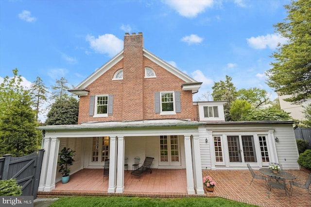2720 35th Pl NW, Washington, DC 20007 - back of property with french doors, a chimney, fence, brick siding, and a wooden deck
