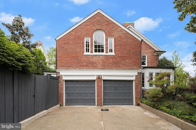 2720 35th Pl NW, Washington, DC 20007 - view of side of property featuring brick siding, a garage, concrete driveway, and a chimney