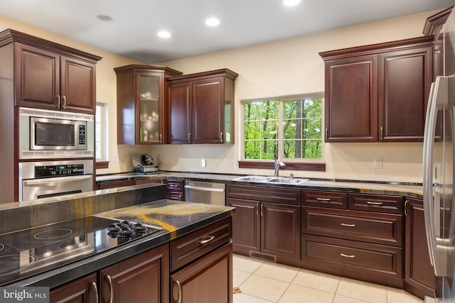 1982 Whyte Ln, Spring Grove, PA 17362 - kitchen with appliances with stainless steel finishes, a sink, light tile patterned floors, recessed lighting, and glass insert cabinets