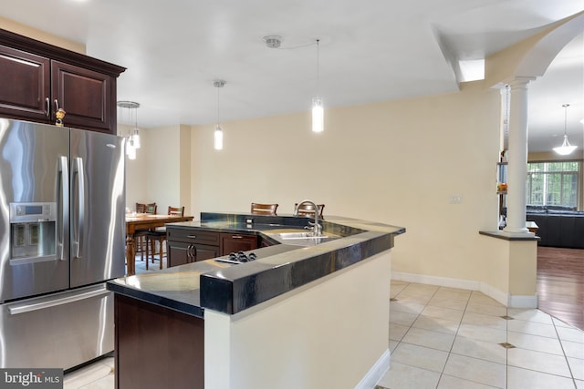 1982 Whyte Ln, Spring Grove, PA 17362 - kitchen with stainless steel fridge with ice dispenser, ornate columns, a sink, dark countertops, and a large island