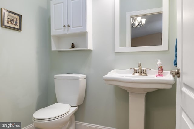 1982 Whyte Ln, Spring Grove, PA 17362 - bathroom featuring toilet, baseboards, and a chandelier