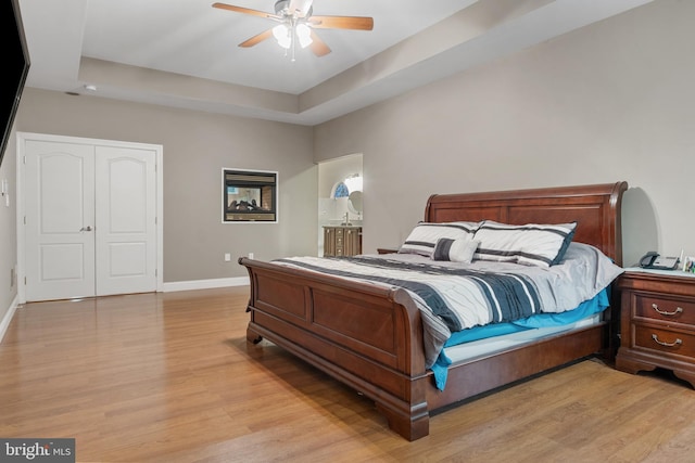 1982 Whyte Ln, Spring Grove, PA 17362 - bedroom with light wood-style flooring, baseboards, a tray ceiling, and a ceiling fan