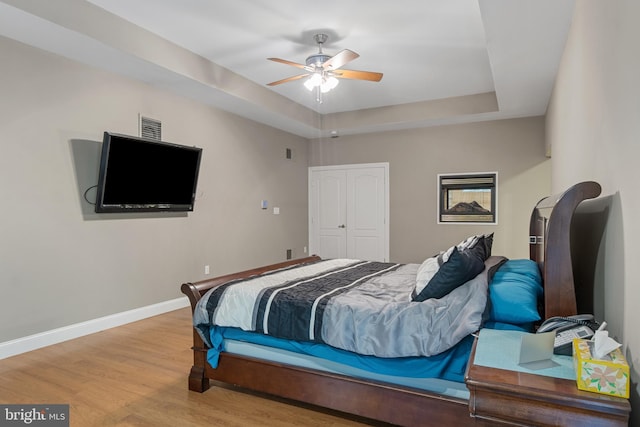 1982 Whyte Ln, Spring Grove, PA 17362 - bedroom featuring wood finished floors, a tray ceiling, baseboards, ceiling fan, and a closet