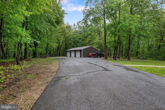 1982 Whyte Ln, Spring Grove, PA 17362 - view of front facade featuring a garage, an outbuilding, and a wooded view