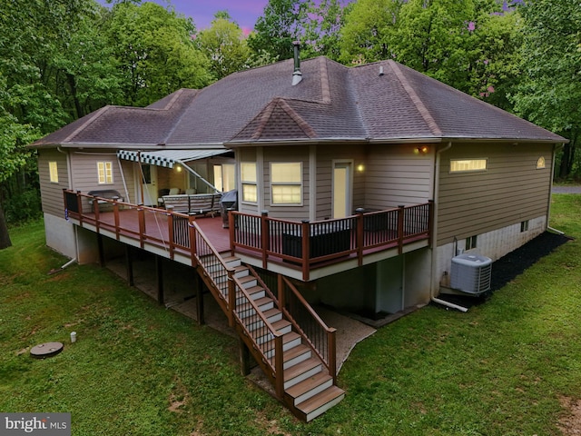 1982 Whyte Ln, Spring Grove, PA 17362 - back of house at dusk featuring a deck, cooling unit, a yard, a shingled roof, and stairs