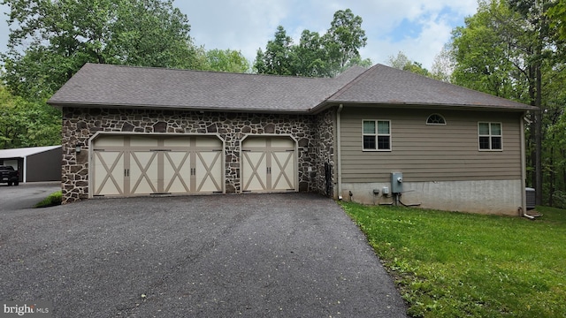 1982 Whyte Ln, Spring Grove, PA 17362 - view of side of property featuring stone siding, a garage, a yard, and driveway
