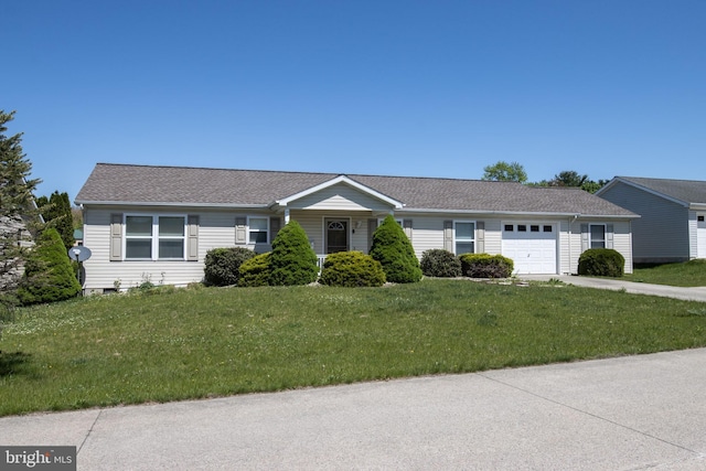 359 Towpath Ln, Pine Grove, PA 17963 - ranch-style home with concrete driveway, an attached garage, a shingled roof, and a front lawn