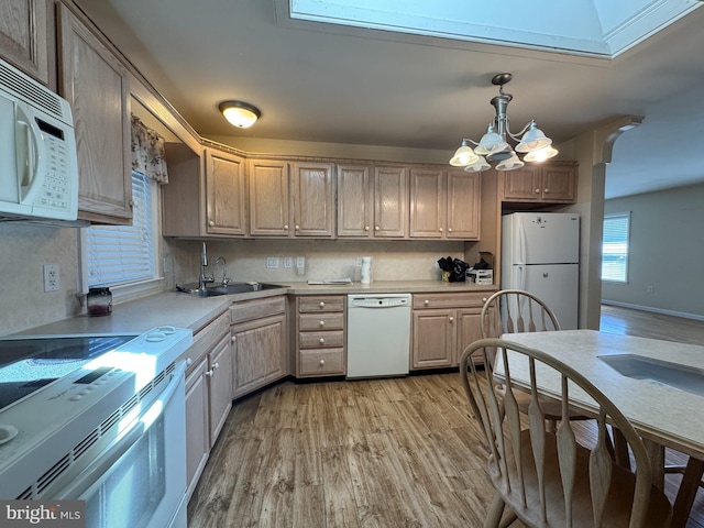 359 Towpath Ln, Pine Grove, PA 17963 - kitchen with a sink, light countertops, a chandelier, white appliances, and light wood-style flooring