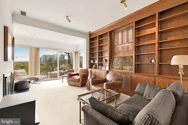 living area featuring carpet floors, recessed lighting, built in shelves, and visible vents