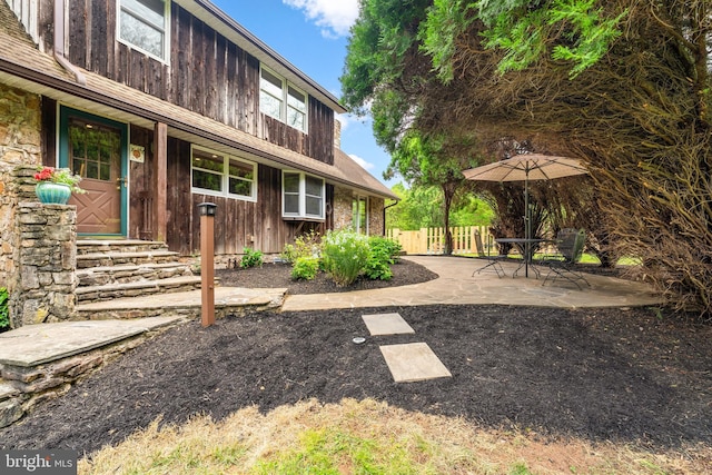 back of house with fence and a patio