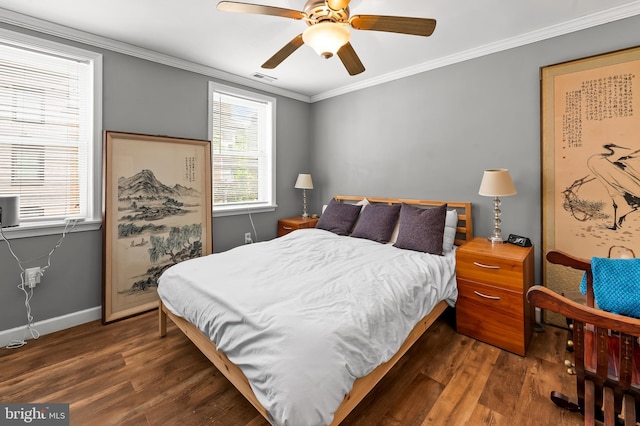bedroom featuring visible vents, ornamental molding, baseboards, and wood finished floors