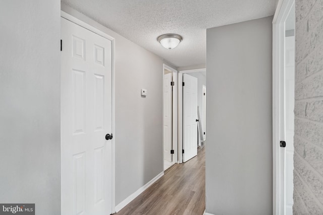 16 S Van Dorn St Unit 406, Alexandria, VA 22304 - hall with wood finished floors, a textured ceiling, and baseboards