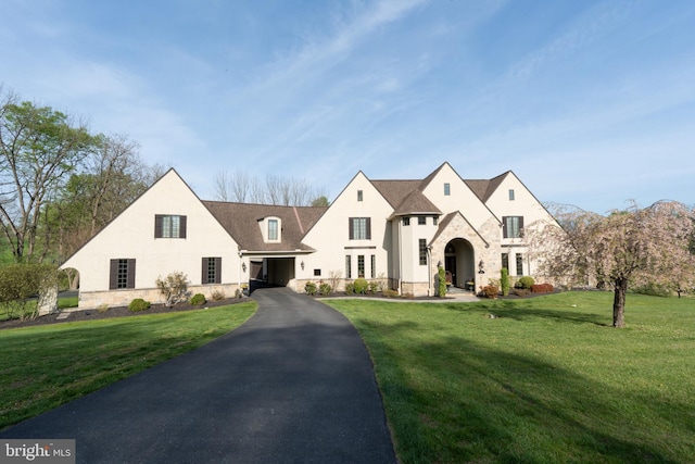 2795 Southwick Dr, Lancaster, PA 17601 - french country style house with stucco siding, a front yard, stone siding, and aphalt driveway