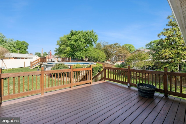 wooden deck with a fenced in pool, a fenced backyard, and a lawn