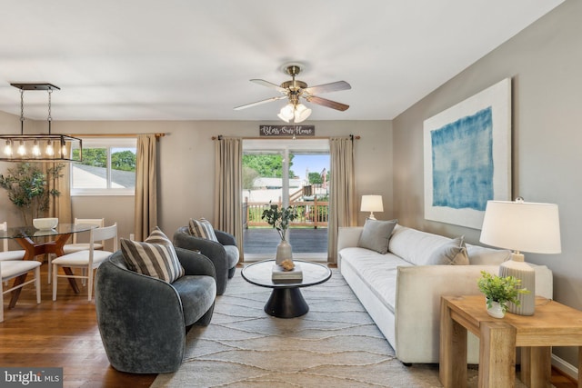 living area with ceiling fan and wood finished floors