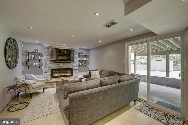 living area featuring light tile patterned floors, a fireplace, recessed lighting, and baseboards