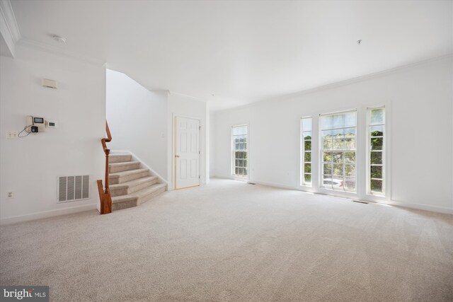 13901 Chatterly Pl, Germantown, MD 20874 - unfurnished living room featuring crown molding, stairway, and light colored carpet