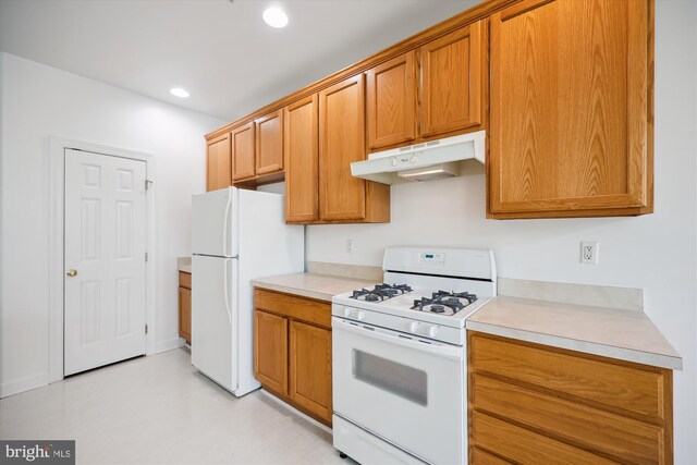 13901 Chatterly Pl, Germantown, MD 20874 - kitchen with white appliances, under cabinet range hood, light countertops, recessed lighting, and brown cabinets