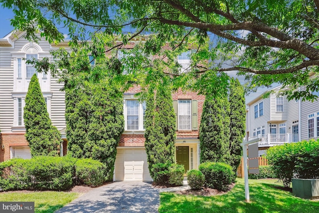 13901 Chatterly Pl, Germantown, MD 20874 - multi unit property with brick siding, driveway, a garage, and a front yard