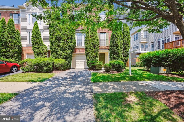 13901 Chatterly Pl, Germantown, MD 20874 - townhome / multi-family property featuring brick siding, an attached garage, driveway, and a front lawn