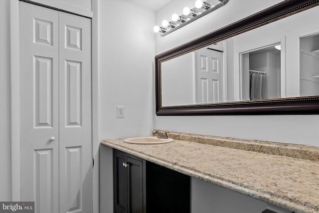 bathroom with vanity and a closet