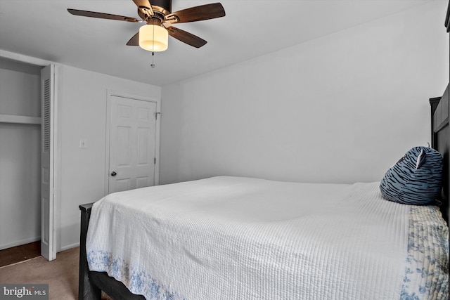 carpeted bedroom featuring baseboards, ceiling fan, and a closet