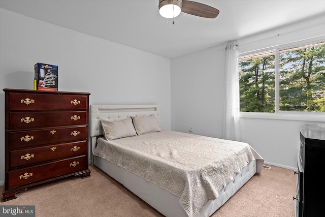 bedroom featuring baseboards and light carpet