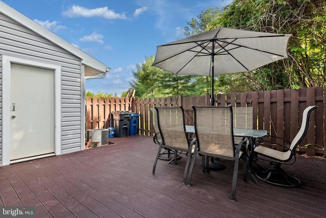 view of patio / terrace with fence, a wooden deck, and outdoor dining area