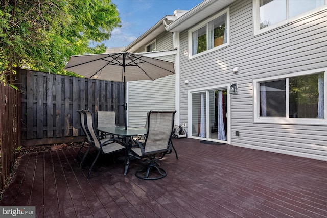 wooden deck featuring outdoor dining area and fence