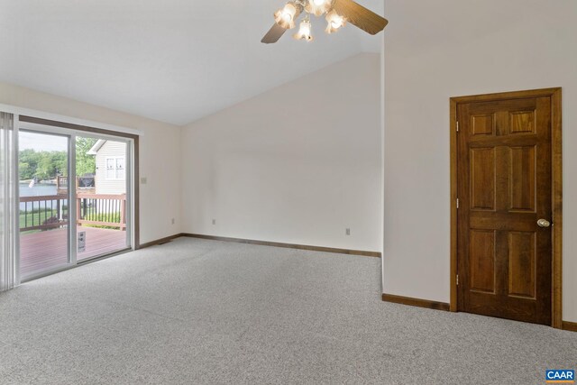 carpeted empty room with baseboards, ceiling fan, and vaulted ceiling