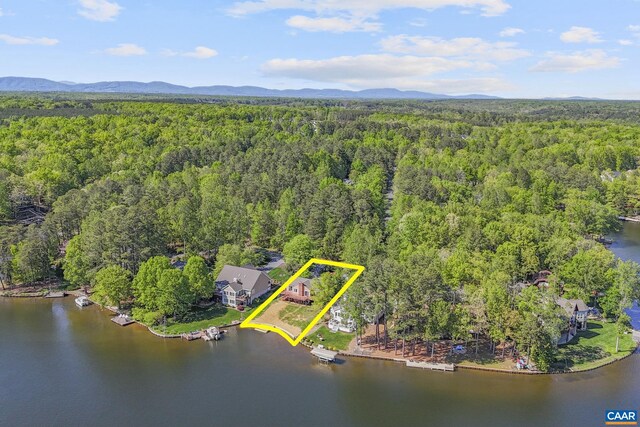 birds eye view of property with a water and mountain view and a forest view