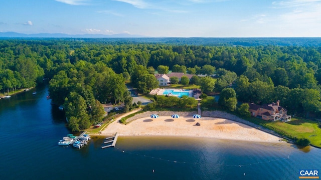 drone / aerial view featuring a forest view and a water view
