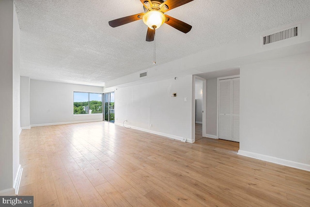 unfurnished room with a ceiling fan, a textured ceiling, and visible vents