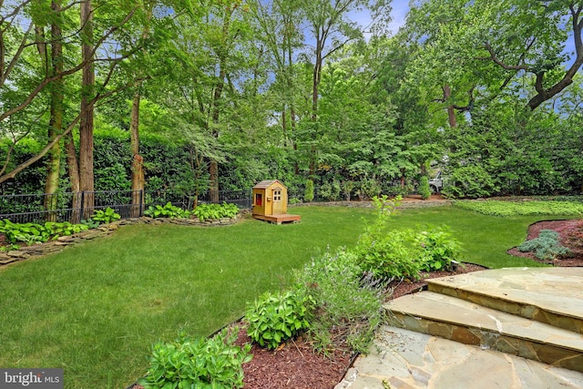 view of yard with a shed and an outbuilding